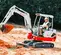 White, red and gray TAKEUCHI 4,000-5,000 lb. Mini Excavator, Zero Tail Swing