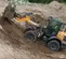 Orange and black Case wheel loader on a dirt incline with a load in the bucket